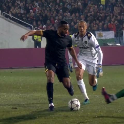 Black with Gold Trim: Keeps the ball close with a defender behind.