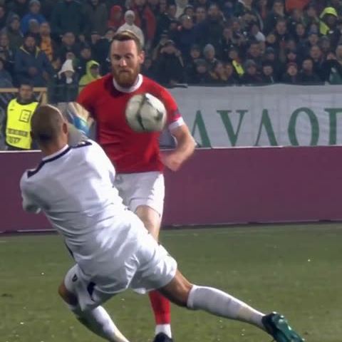 The scorer lifts the ball as the first challenge comes in.